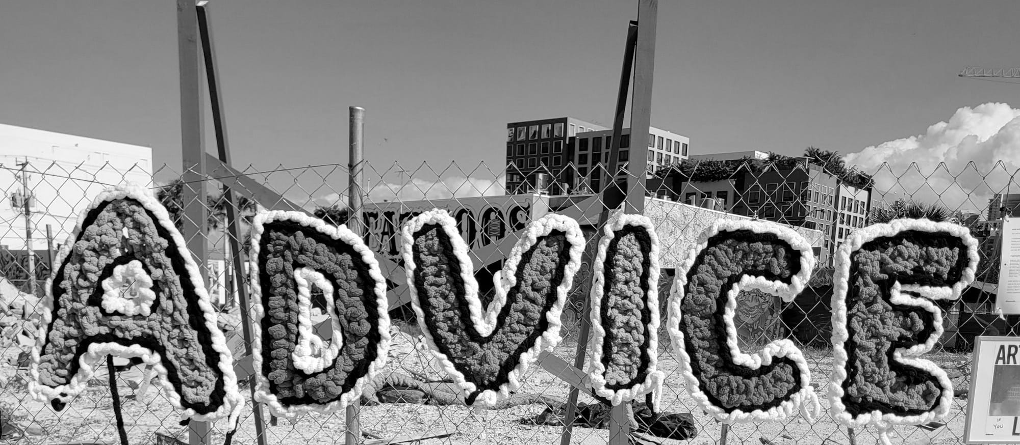 Colorful letters spell out advice on a fence