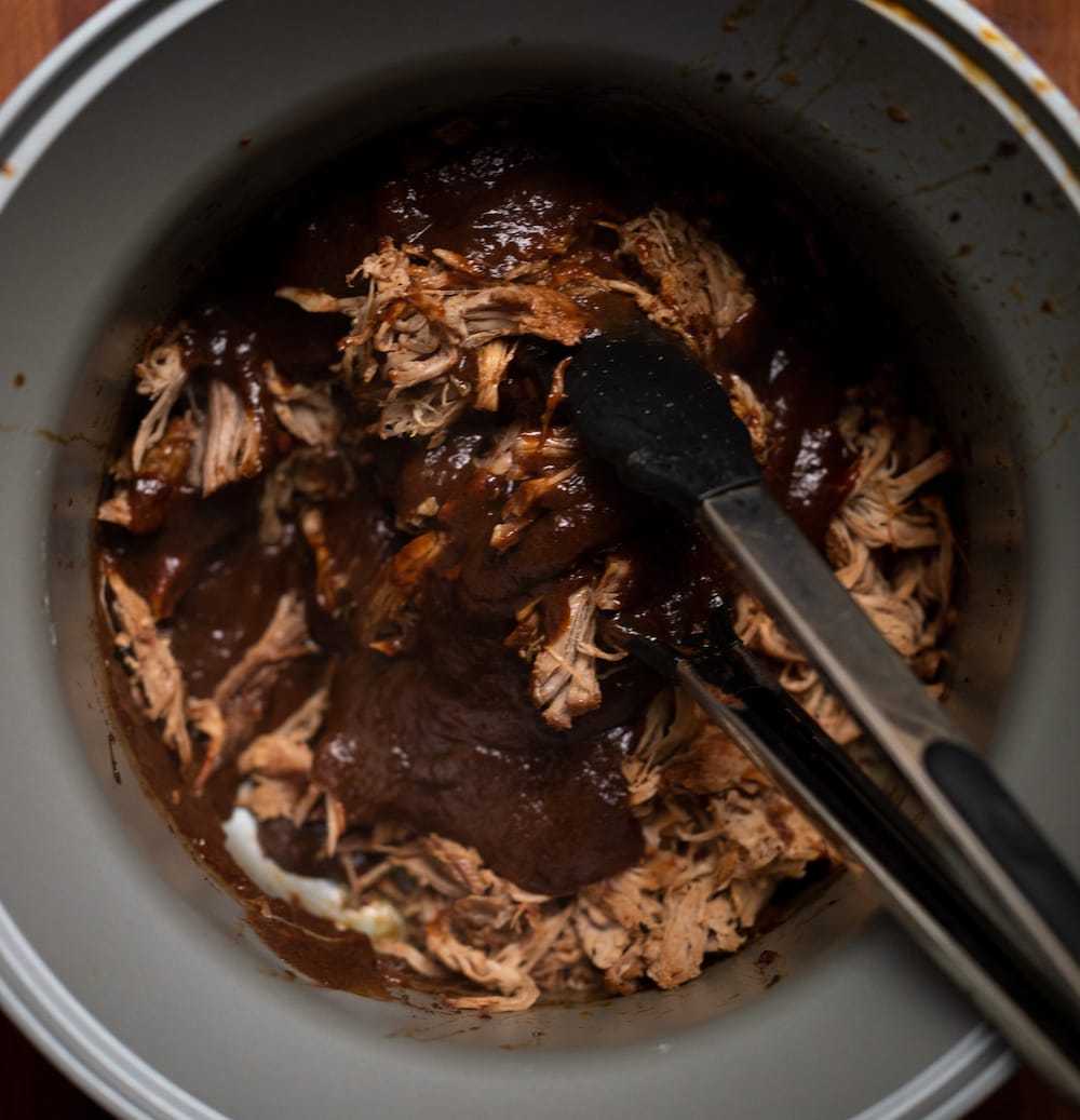 Overhead shot of reduced Texas pulled pork sauce added to the shredded pork