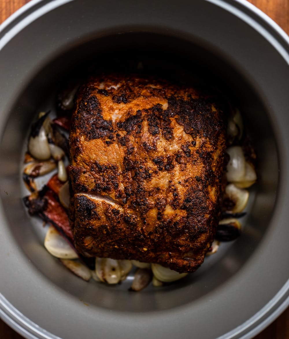 Overhead shot of Texas pulled pork in a slow cooker before cooking