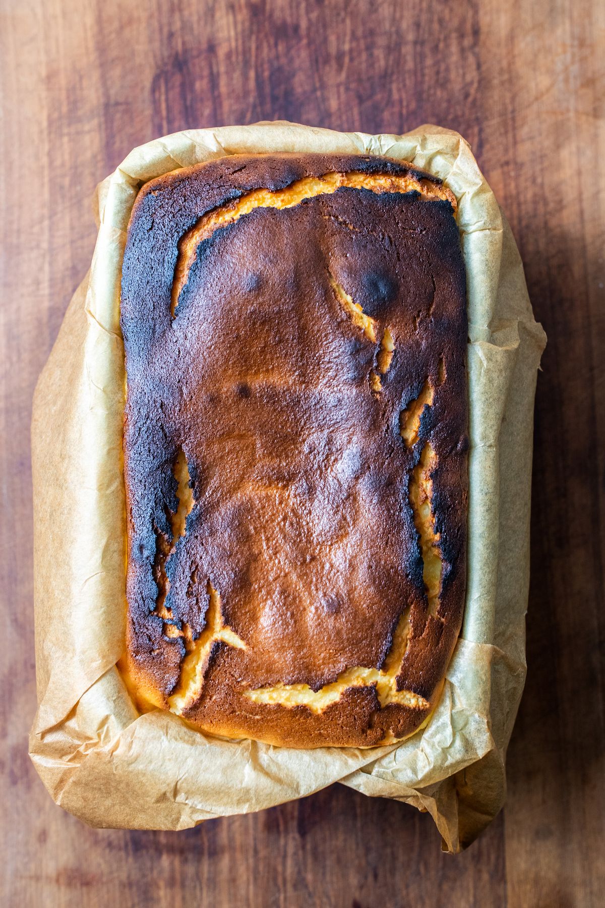 Overhead shot of a loaf pan basque cheesecake after it comes out of the oven