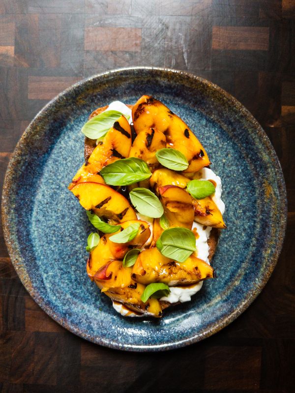 Grilled Peach & Burrata French Toast on a blue plate