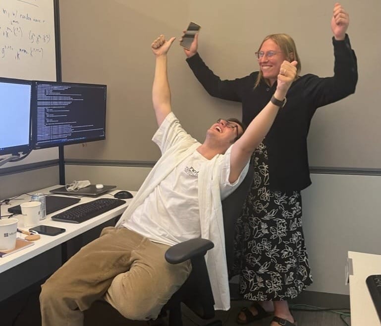 Smart people celebrating in an messy office and monitor