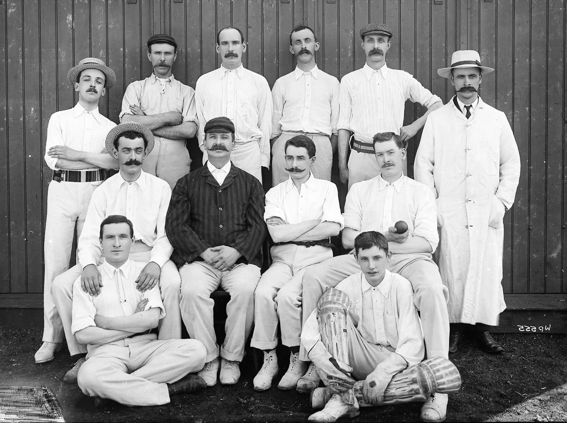 Black and white photograph of a cricket team, many of whom have fabulous mustaches.