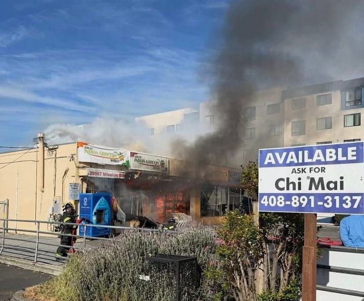 Photograph of an active fire inside Great Indian Grocery Market next door to Red Chili. 