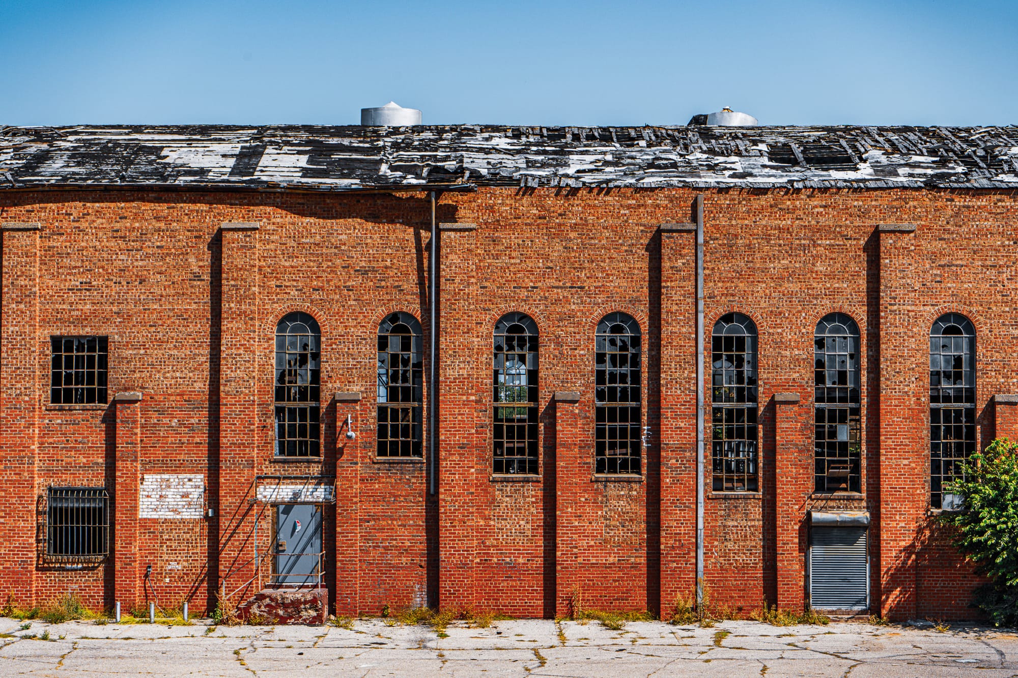 The side of a damaged red brick building.