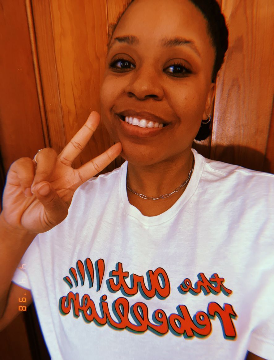 A picture of me in a white art rebellion t shirt