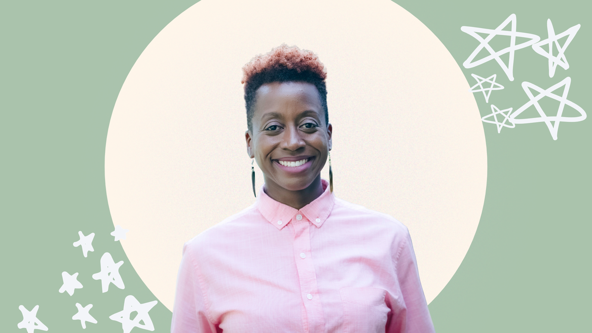 MK Abadoo, a medium brown-skinned African American person smiles. They wear a pink  shirt and have a short, tapered cut.