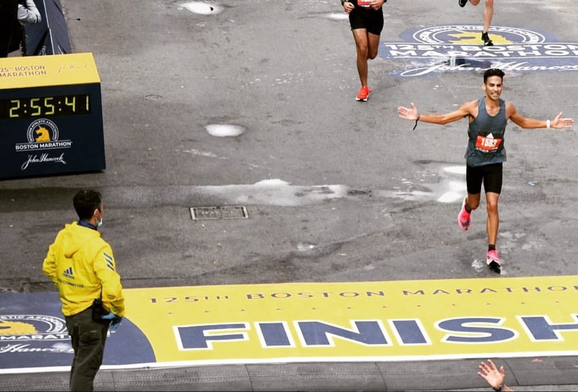 Myself (right) crossing the finish line of the 2021 Boston Marathon. Photo by the Boston Athletic Association.