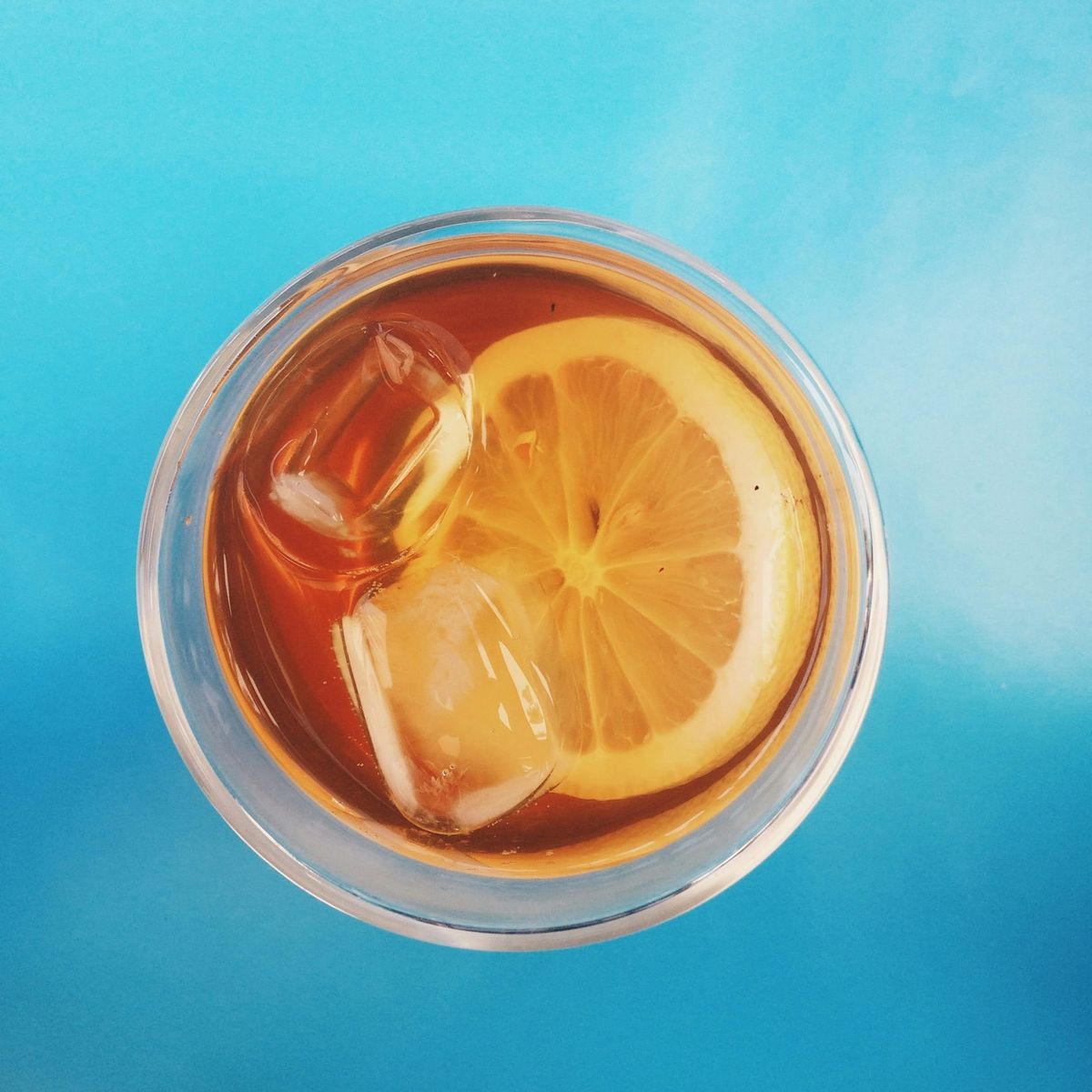 Ice tea from the top down on a blue table. Photo by Julia D'Alkmin on Unsplash. 