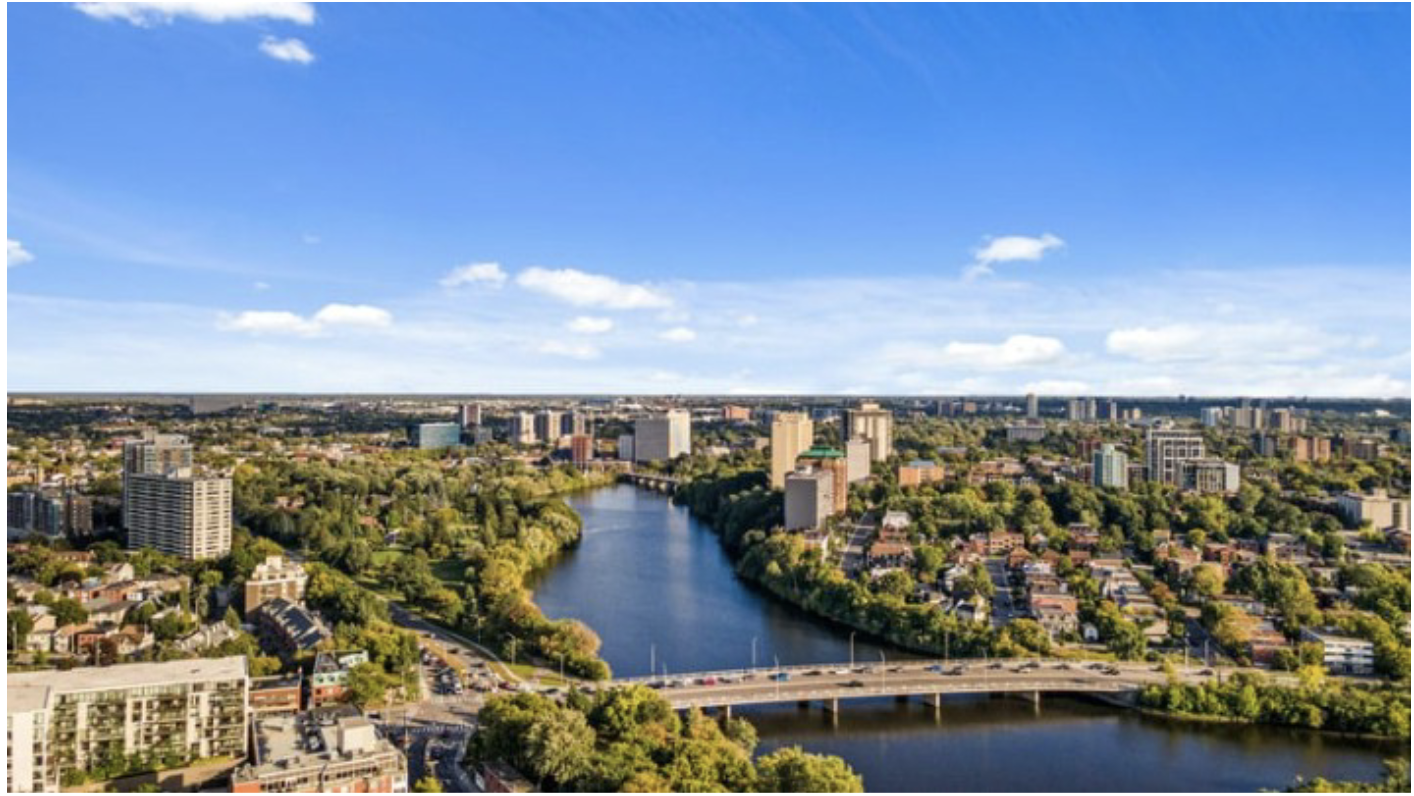 Aerial view of Ottawa showing luxury residential buildings along the Rideau River, highlighting a thriving real estate market in Canada’s capital.