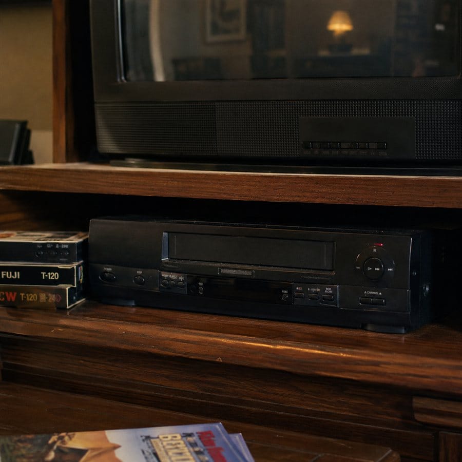 A black VCR with a digital clock display