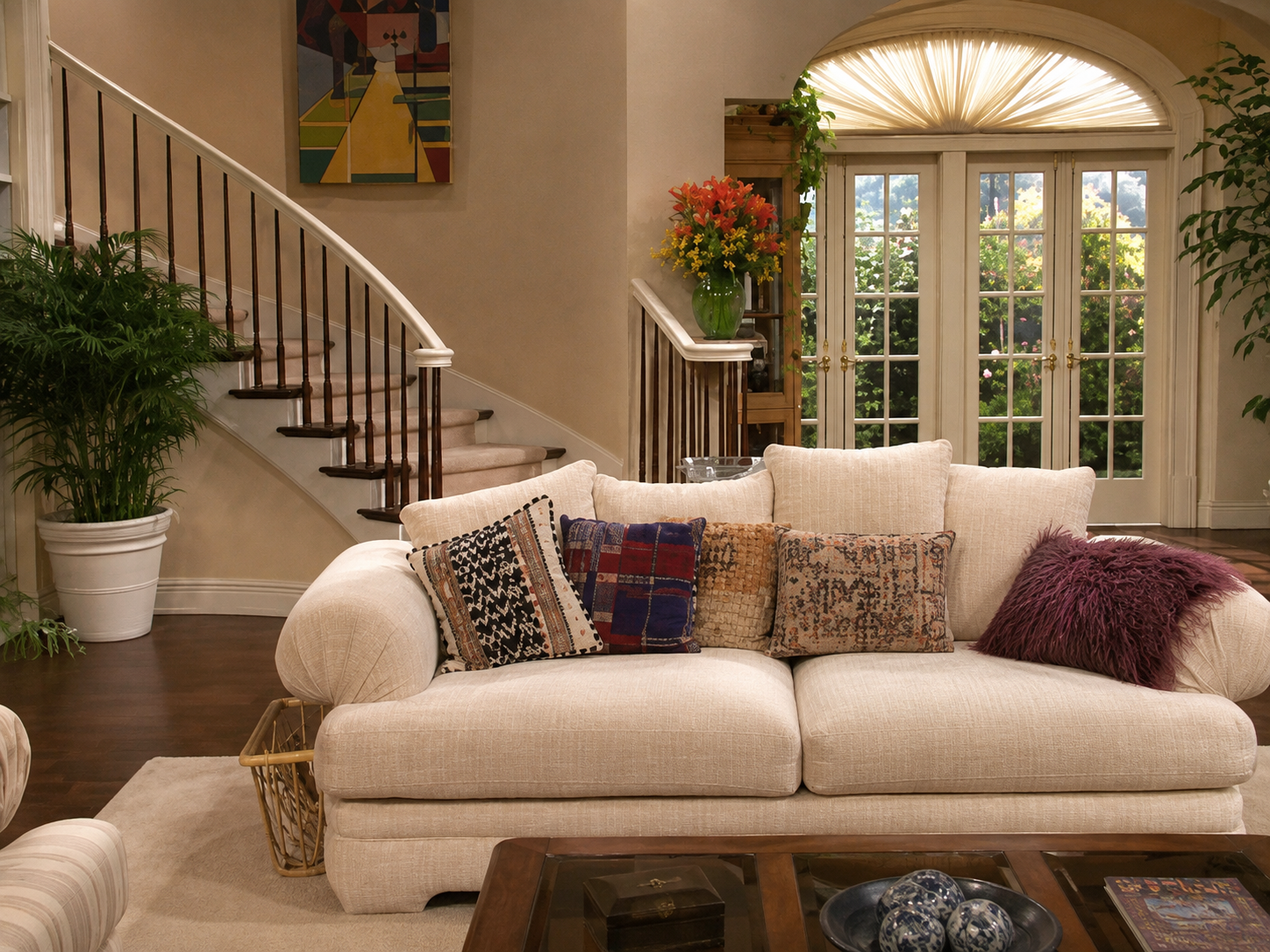 Elegant Bel-Air mansion living room with a sweeping staircase