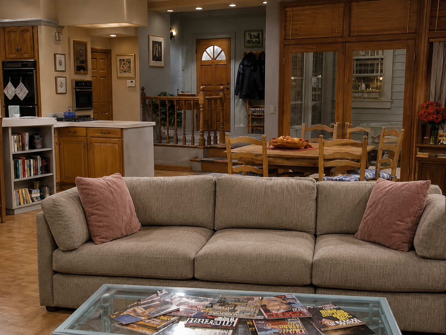 Warm early-1990s suburban living room with a brick fireplace, staircase and plaid sofa