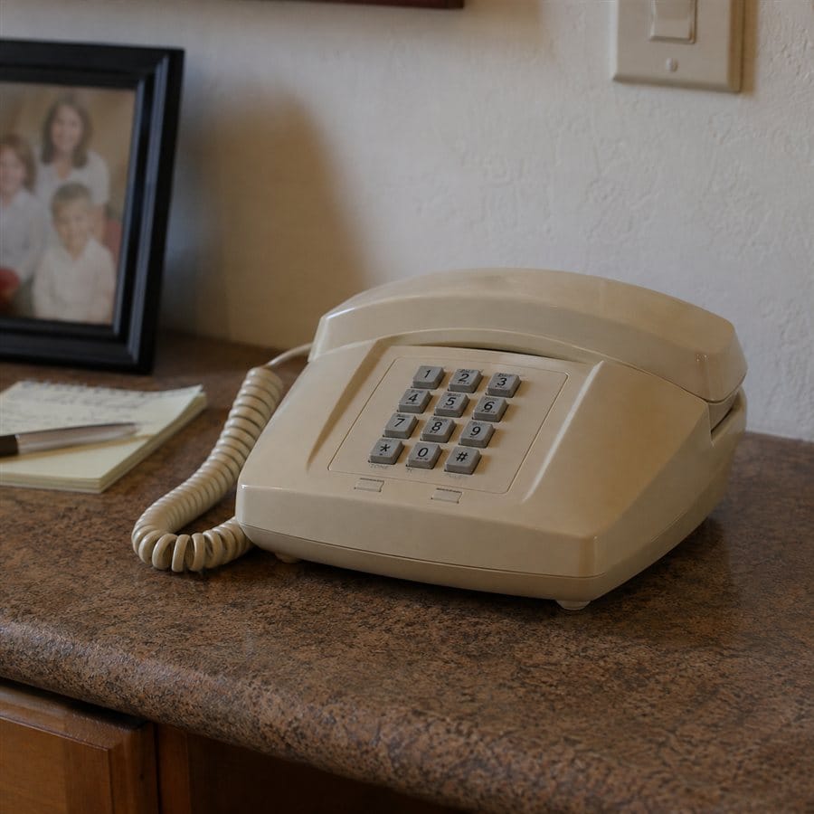 A beige corded landline telephone