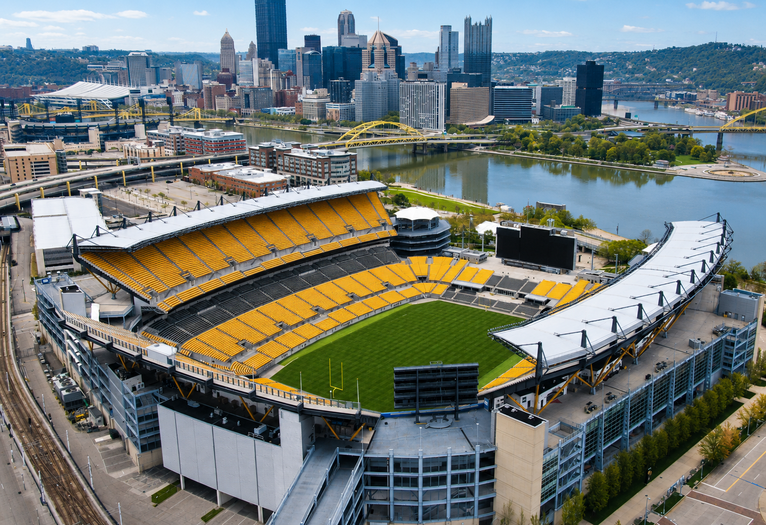 Aerial view of Acrisure Stadium with the Pittsburgh skyline