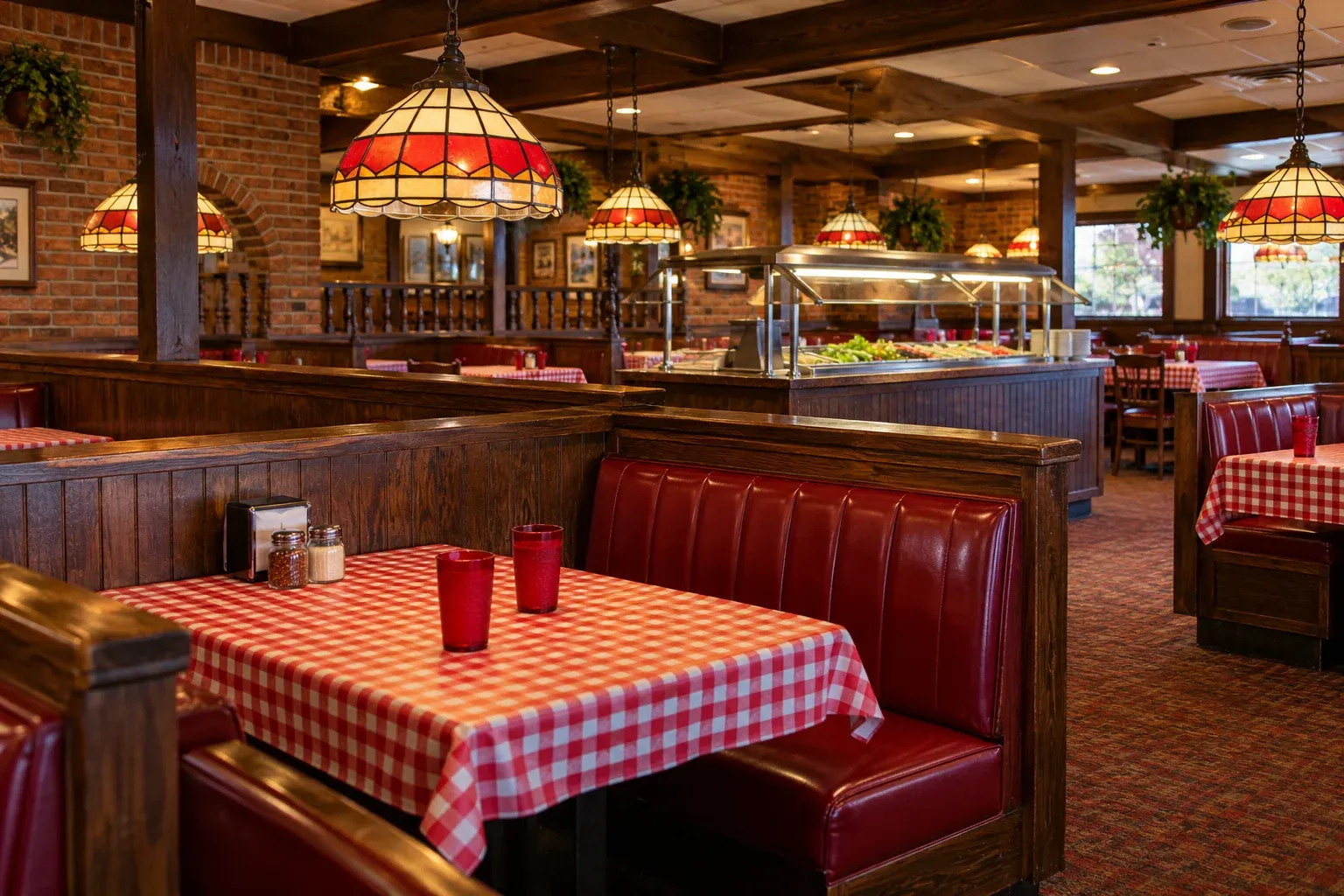Recreated dining room with red booths, checkered tablecloths, stained-glass lamps, and a salad bar.