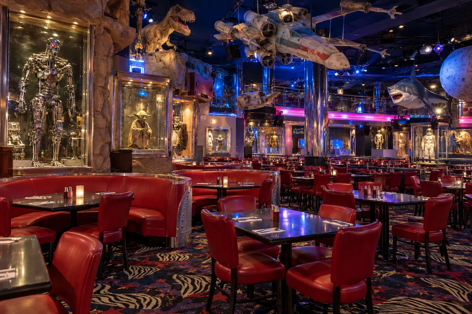 Recreated movie-themed dining room with red seating and film props displayed above and beside the tables.