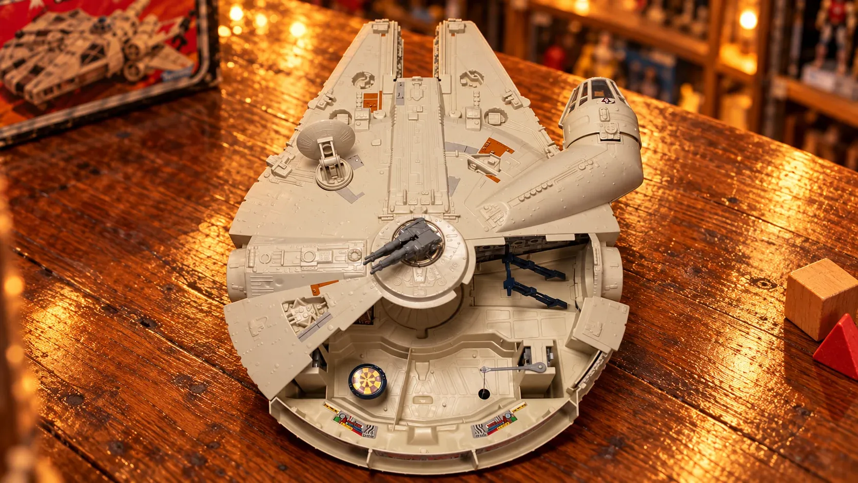 Illustration of a vintage Kenner Millennium Falcon toy on a wooden toy-store counter.
