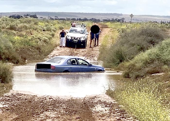 Police News... Driver caught in flood water