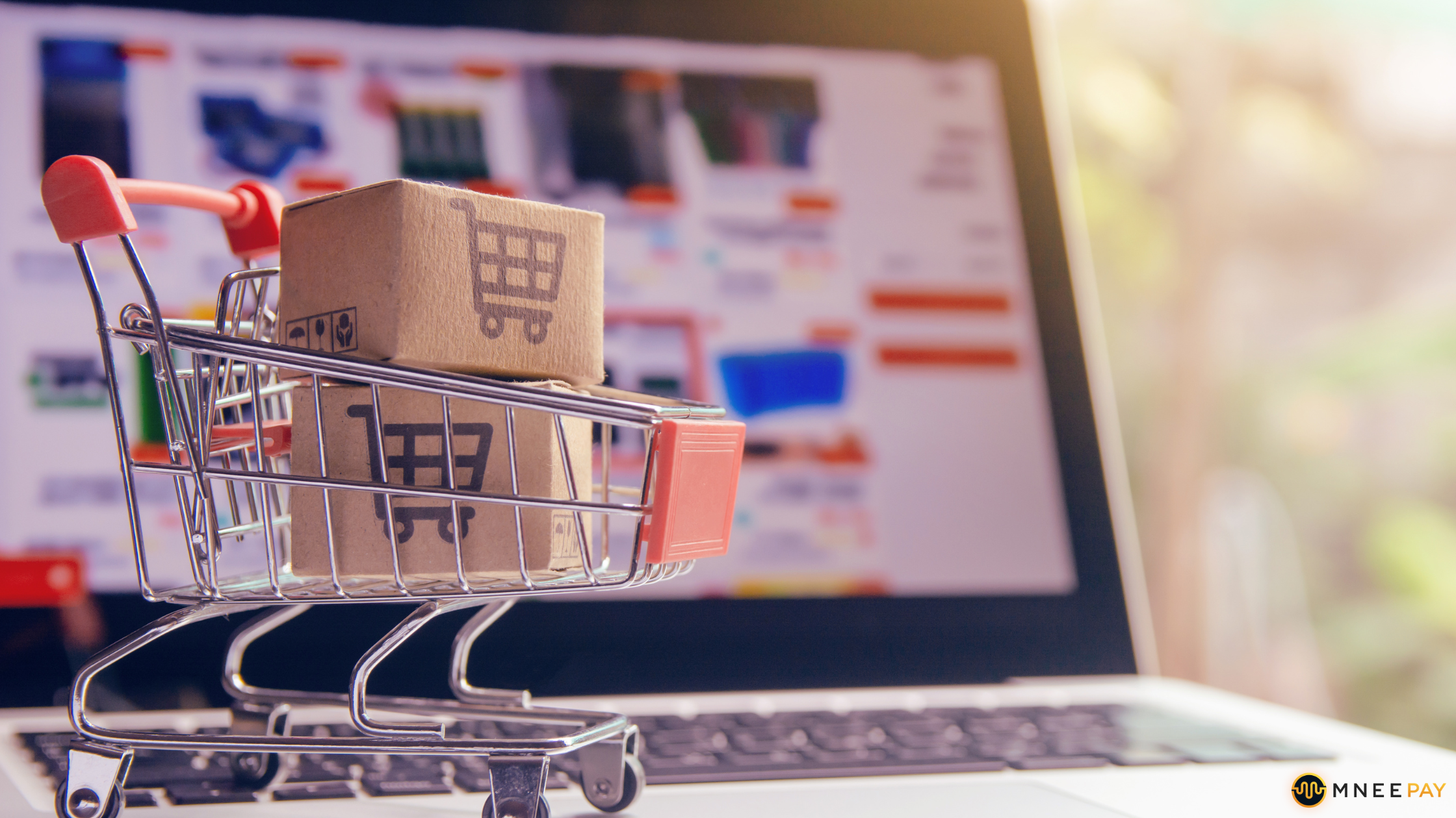 Mini shopping cart and laptop showing online store for cross-border payments