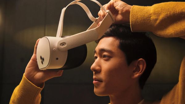 A man pulls a Meta Quest 3S headset onto his head