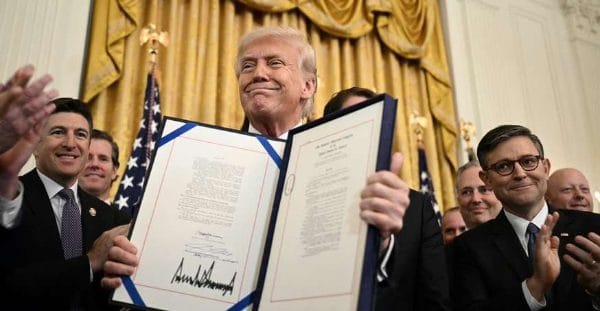Donald Trump holding document
