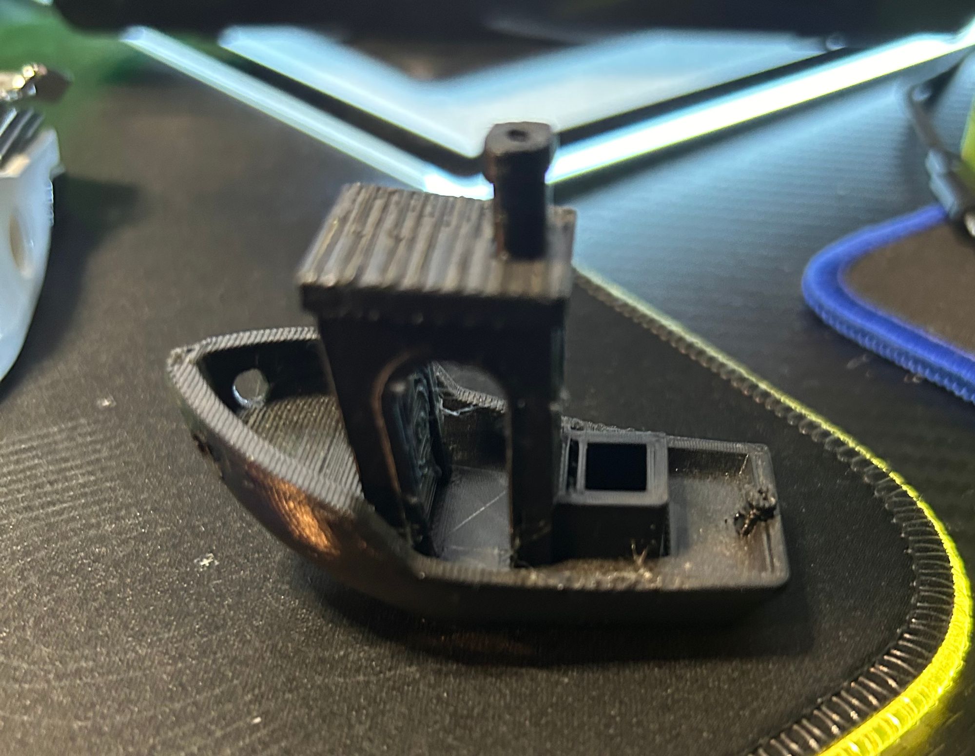 A small black object on a black surface

Description automatically generated