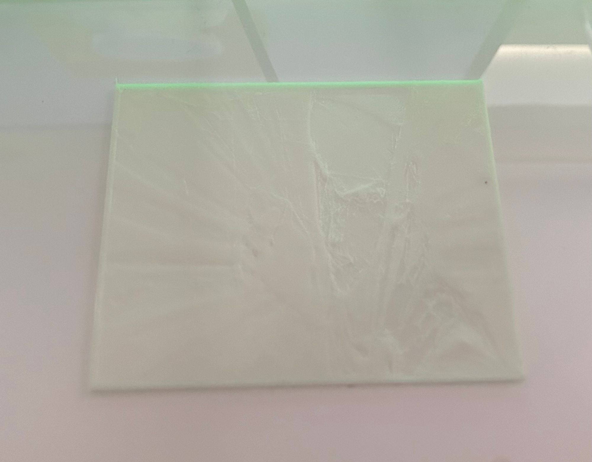 A white square object with green light

Description automatically generated