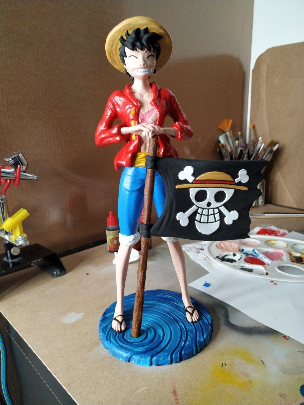 A statue of a cartoon character holding a flag

Description automatically generated