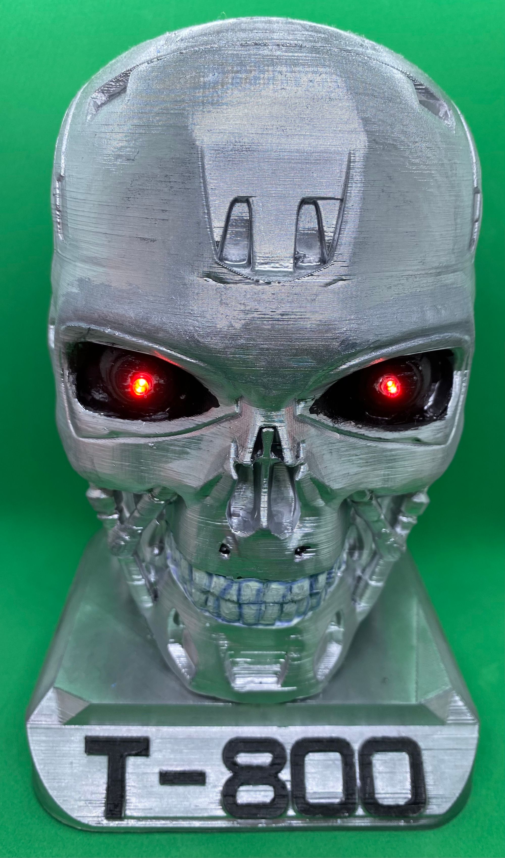 A silver skull with black eyes

Description automatically generated
