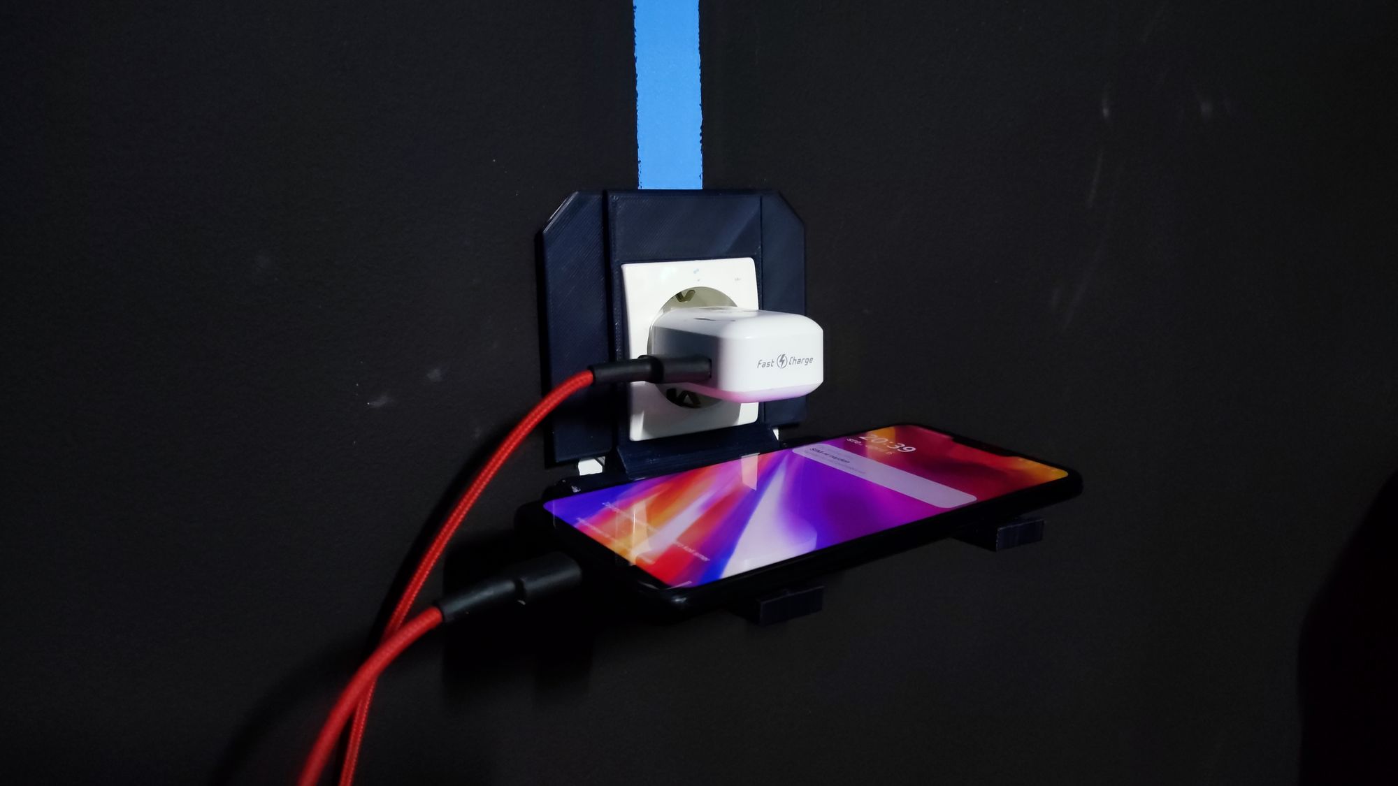 A cell phone charging in a wall

Description automatically generated