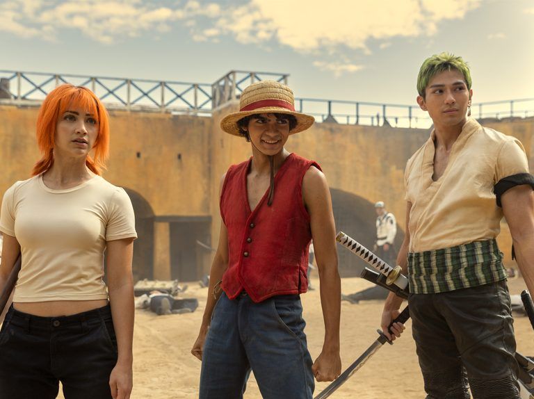 A group of people standing in a desert

Description automatically generated