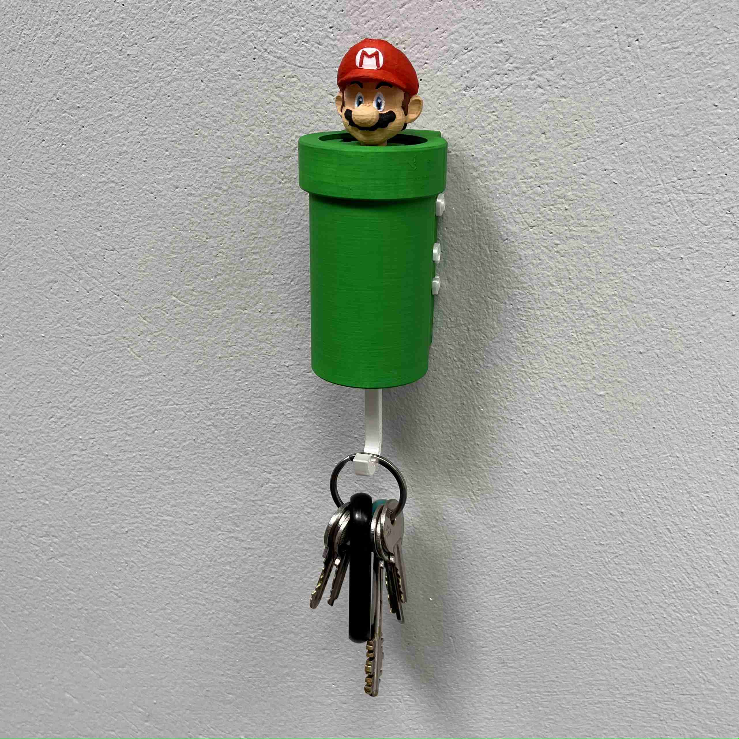 A key holder with a cartoon character

Description automatically generated