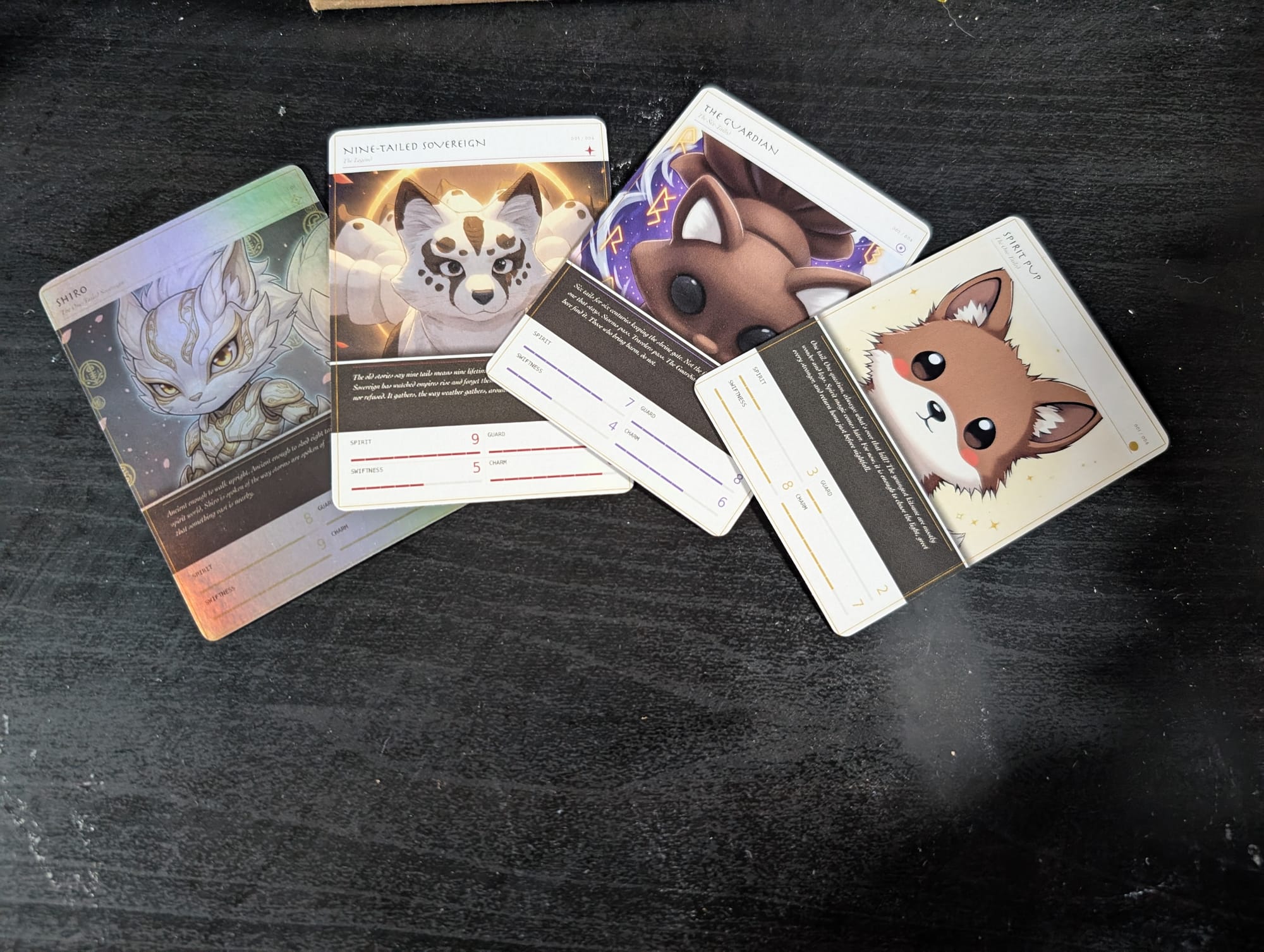 The four Wave 1 Kitsune collector cards fanned out