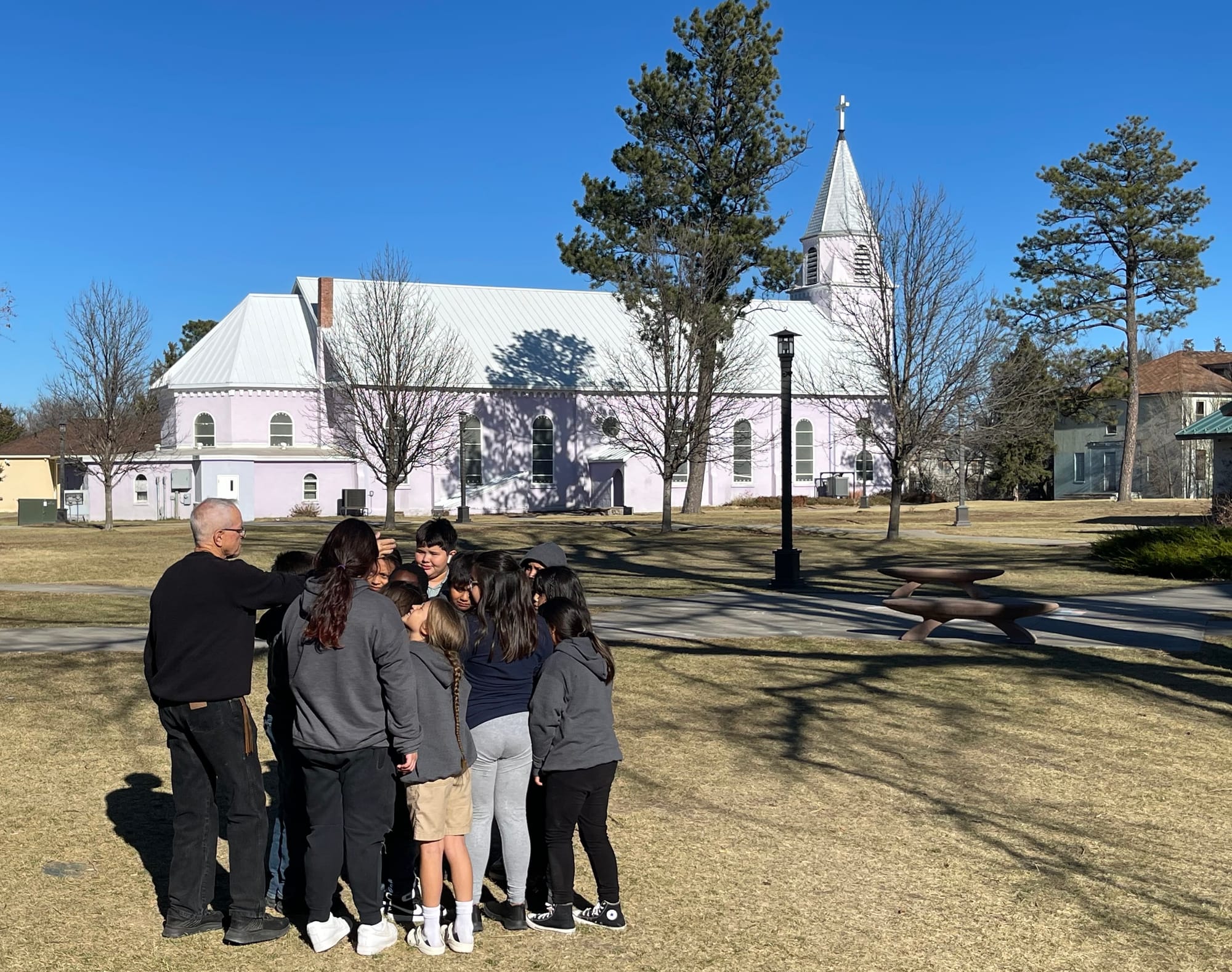 Students huddle up before recess outside Sapa Un Jesuit Academy