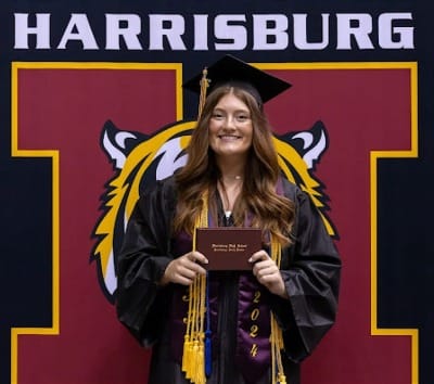 A student is shown in her cap and gown at graduation in Harrisburg, South Dakota