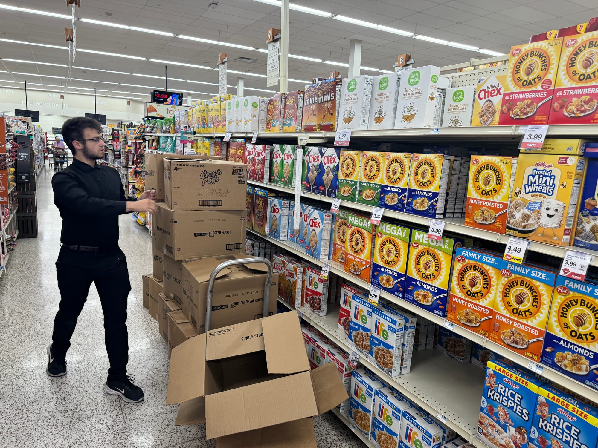 A Hy-Vee employee stocks cereal boxes on the shelves at the 26th Street location in Sioux Falls, S.D. 