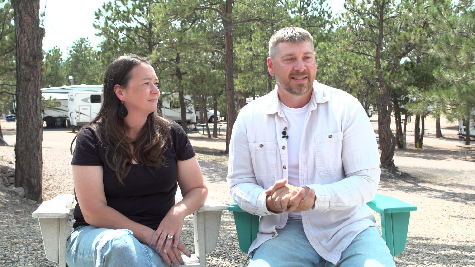 Nicole Weiss (right) and her husband Thad Weiss (left) sit at the firepit at the KOA Campground they run in Hot Springs, S.D, 