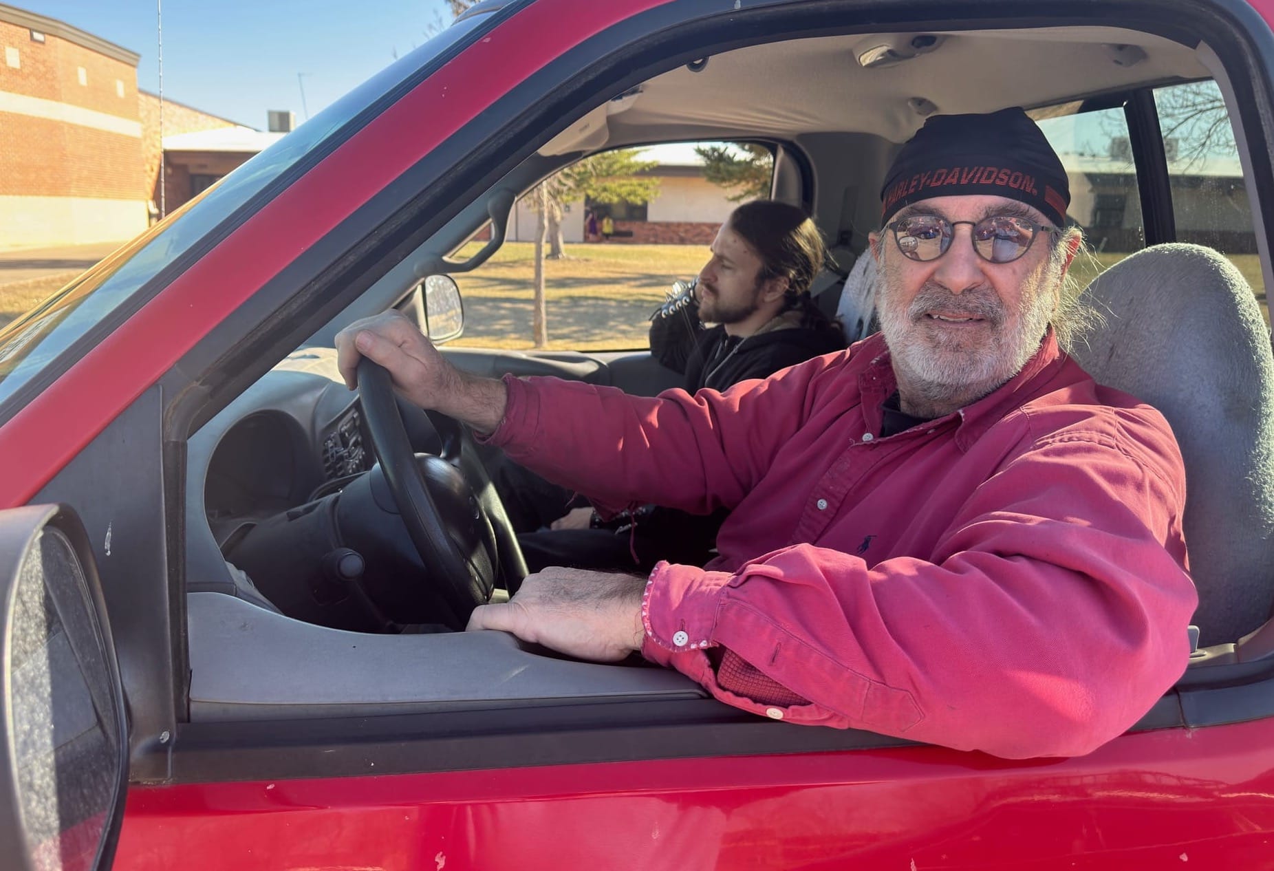 James Lay, 67, and son Sam, 27, both of Rapid City, S.D., wait in line at a Feeding South Dakota mobile food bank on March 27, 2025, in Box Elder, S.D.
