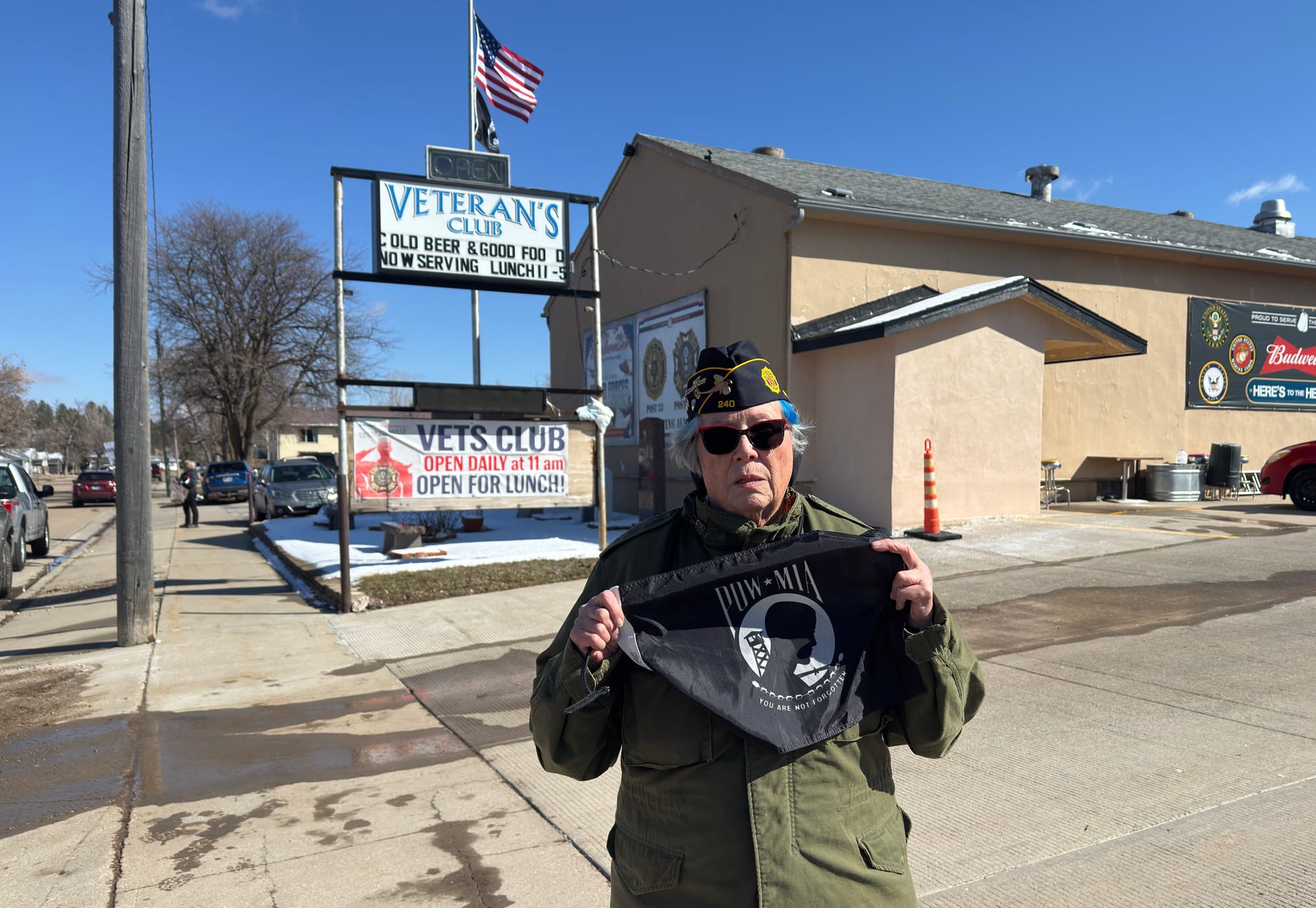 Roseanna Renaud holds a POW-MIA flag outside the Veteran's Club in Sturgis.