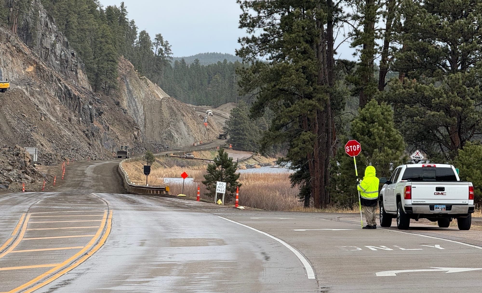 A construction worker holds a stop sign for traffic on US 385 in the Black Hills.