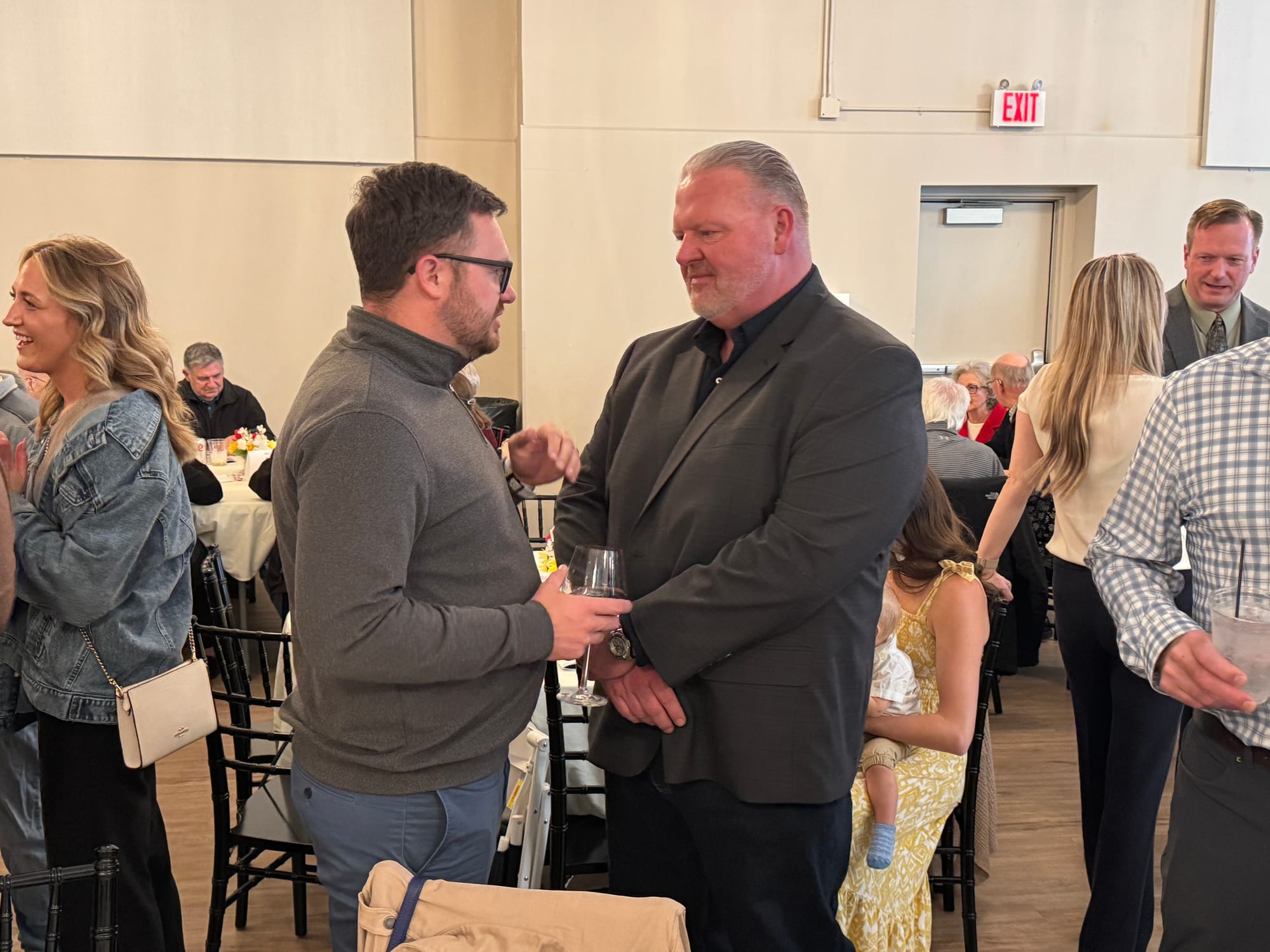 Florida-based political operative Matt Hurley (left) speaks with Toby Doeden at the Brown County Republican Party Lincoln Day Dinner