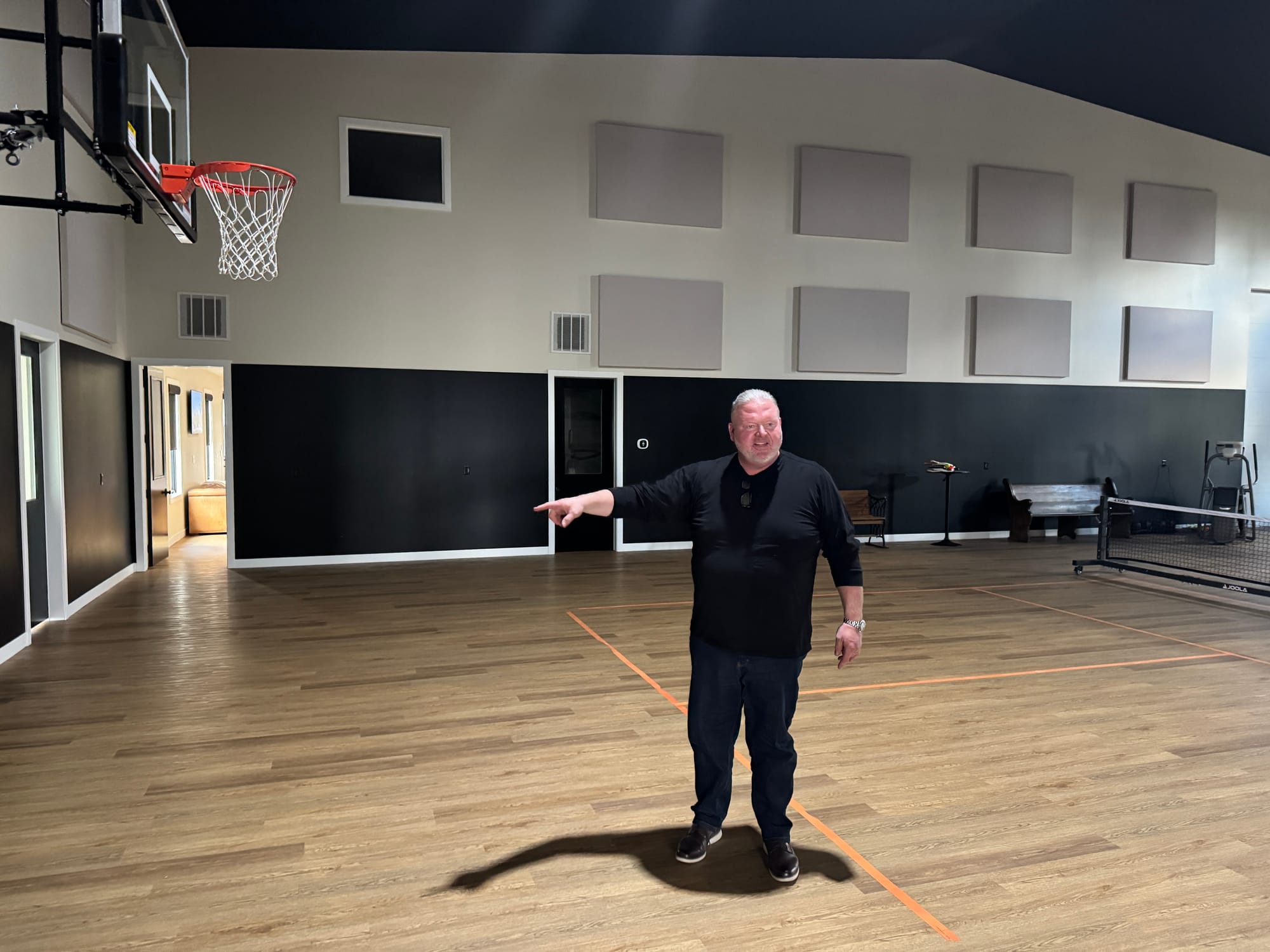 Toby Doeden, a former football player and shot put standout at Groton High School, shows off the basketball court at his home and office complex in Aberdeen.