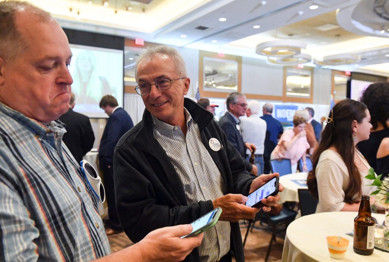 Lee Schoenbeck checks election results at a watch party on June 7, 2022, at the Hilton Garden Inn