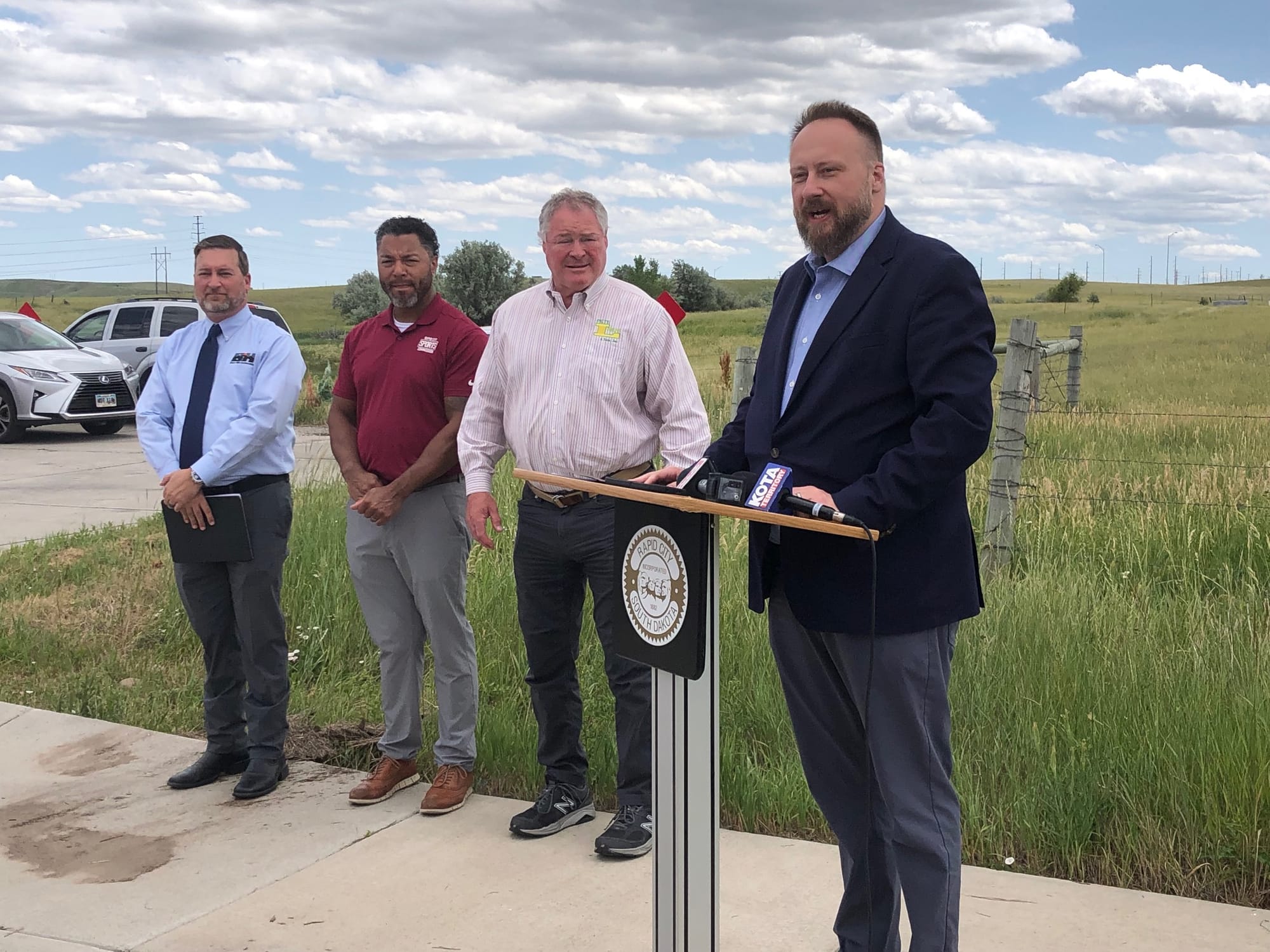 Wes Ashton of Black Hills Energy, Domico Rodriguez of the Rapid City Sports Commission, Pete Lien of Pete Lien & Sons Inc. and Mayor Jason Salamun announce land donation of 22.78 acres for indoor sports facility and other development on Monday, June 26, 2025, at the intersection of Seger Drive and 143rd Ave. in Rapid City, S.D. 