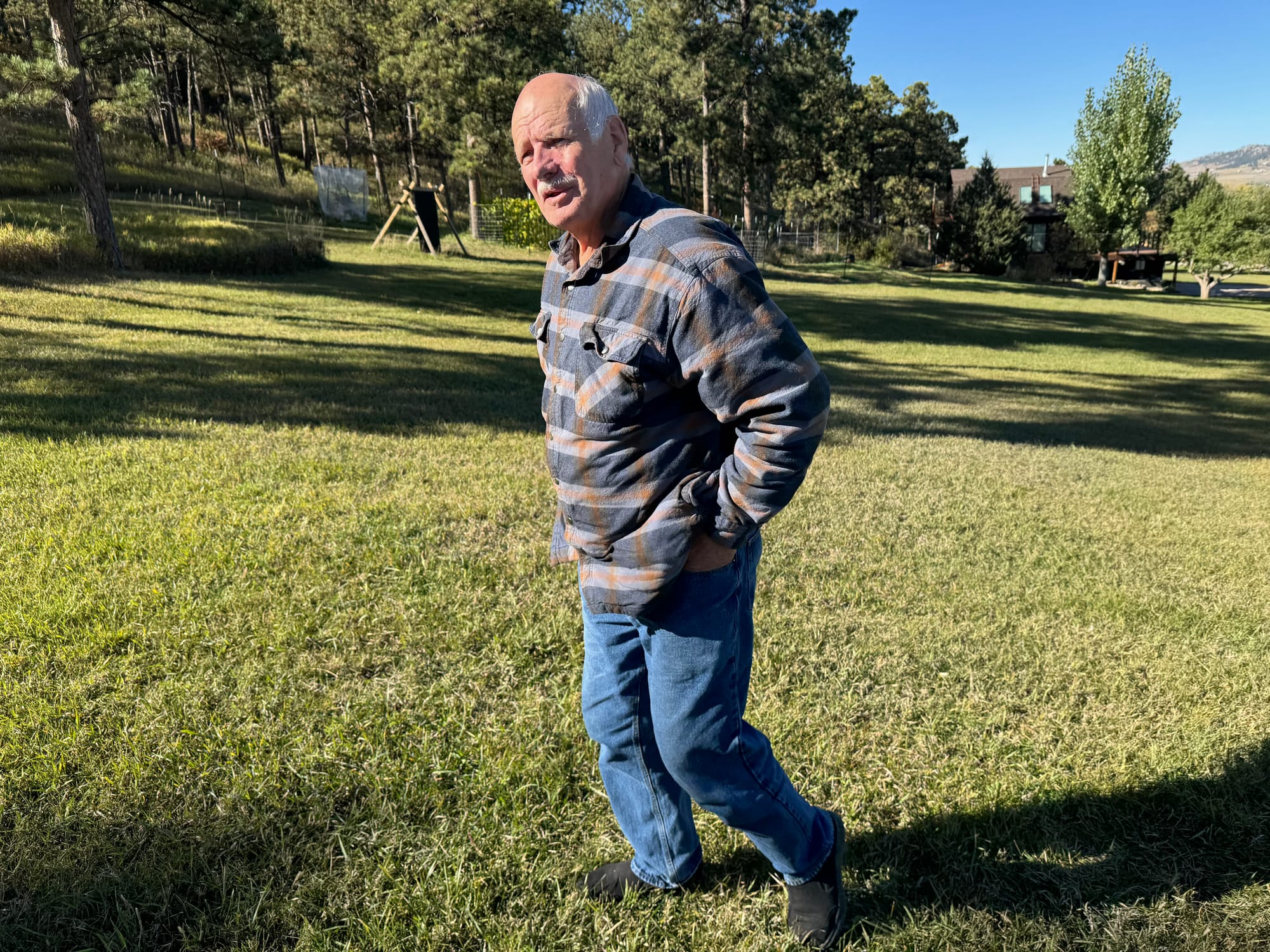 Phil Anderson, municipal board chairman in Piedmont, S.D., shown on Oct. 23, 2025, walks on land next to where a limestone mine is expected to begin operations in 2026. (