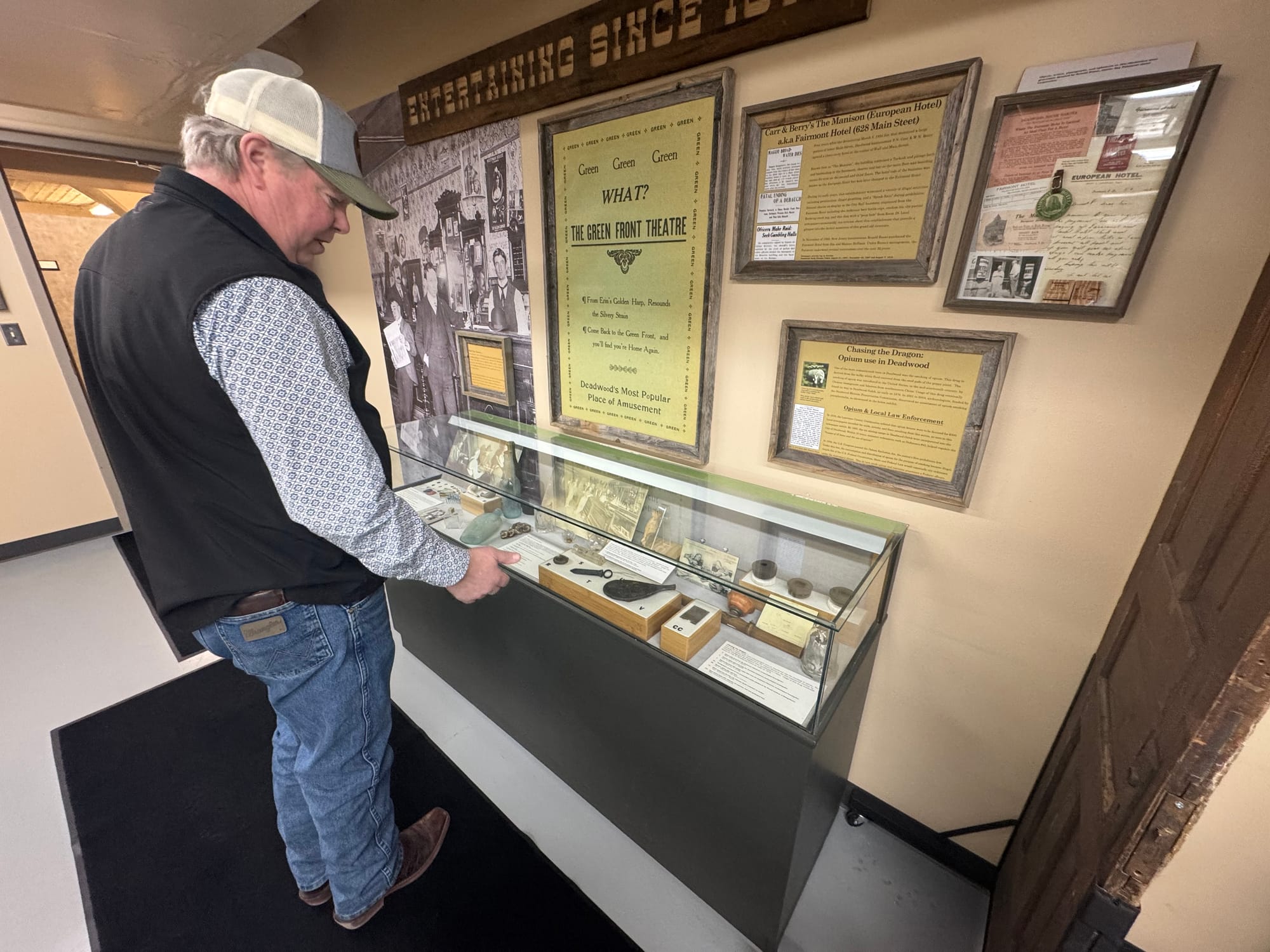 Deadwood, S.D., historic preservation officer Kevin Kuchenbecker looks at historic objects