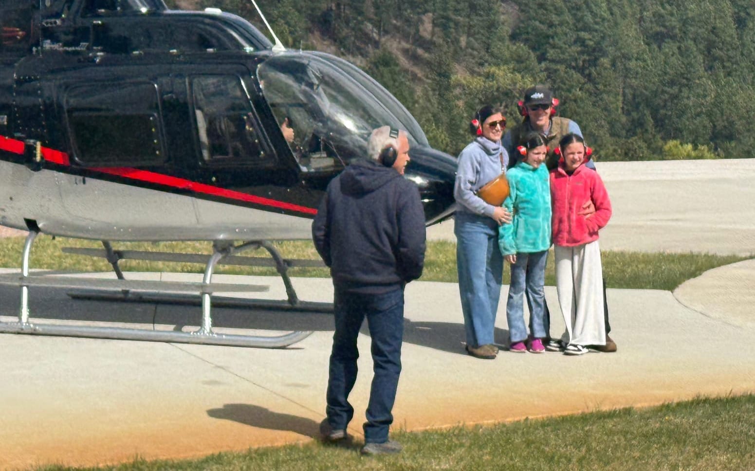 Wisconsin tourists Ryan and Alexis Foley and their daughters, Amelia and Mabel, pose for a photo after taking a scenic helicopter ride
