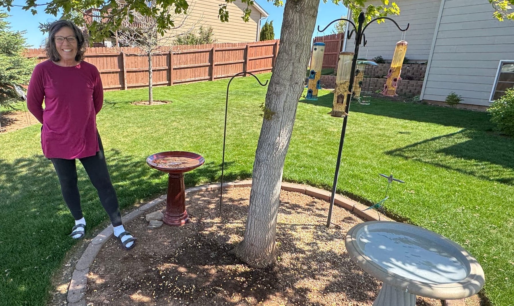 Carolyn Lorge of Black Hawk stands in her backyard