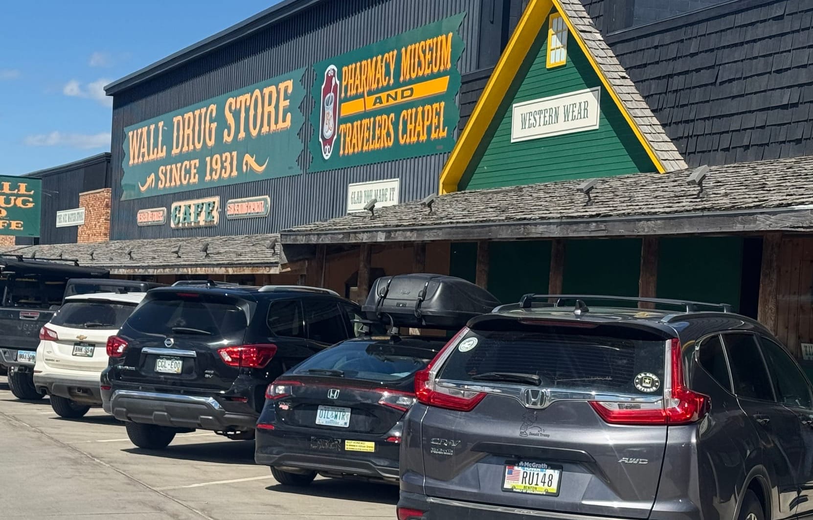 This May 6, 2026 photo of the iconic Wall Drug in Wall, S.D., shows cars from Iowa, New Hampshire, Colorado and South Dakota all parked out front. 